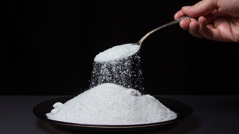 Spoonful of salt being poured