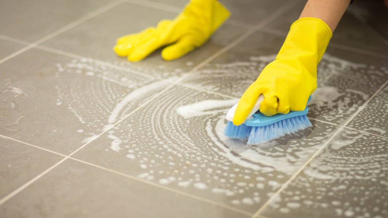 Person scrubbing tiles