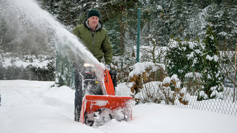 Man pushing a snowblower