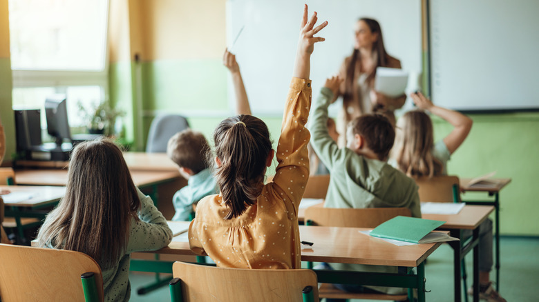 students raising hands