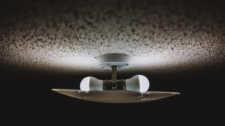 A popcorn ceiling surrounds a light fixture