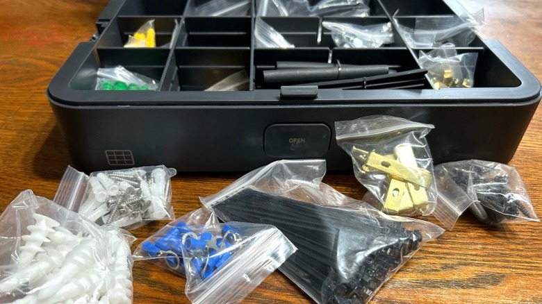 Open BLACKZERO hardware box with assorted bagged materials