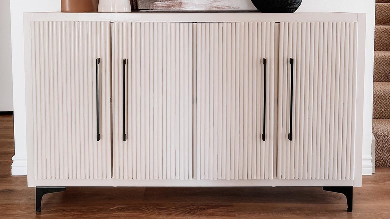 White cabinet with black hardware