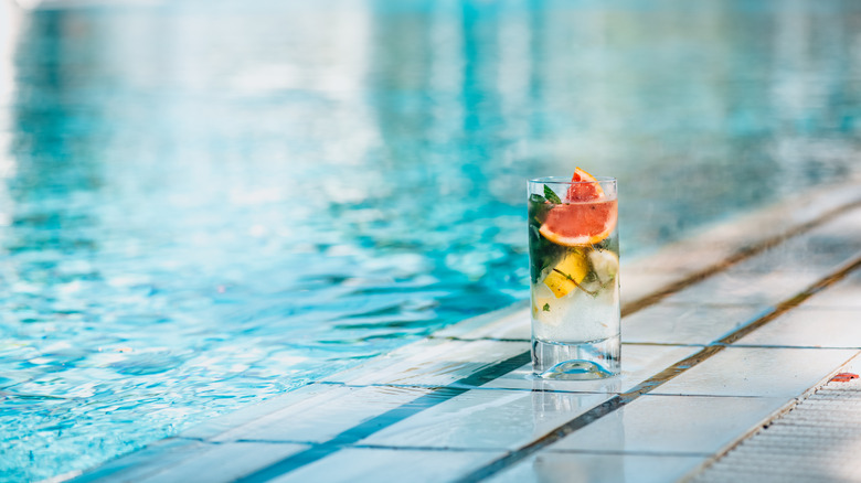 beverage sitting on pool edge