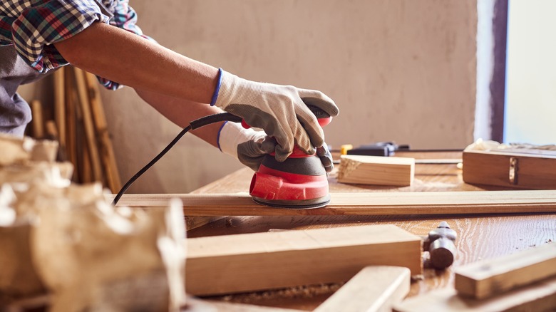 person sanding wood