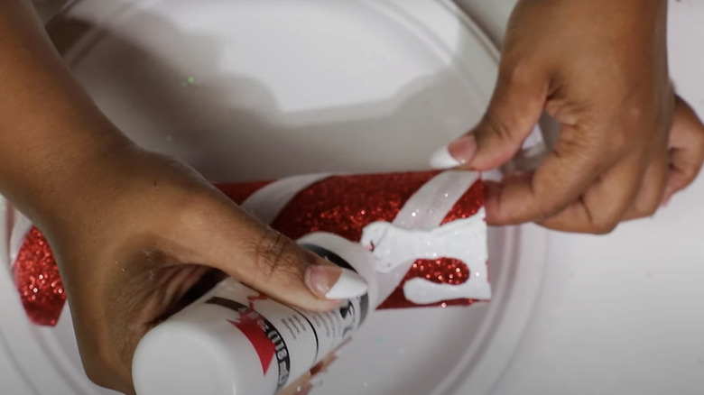 person adding candle dripping with paint