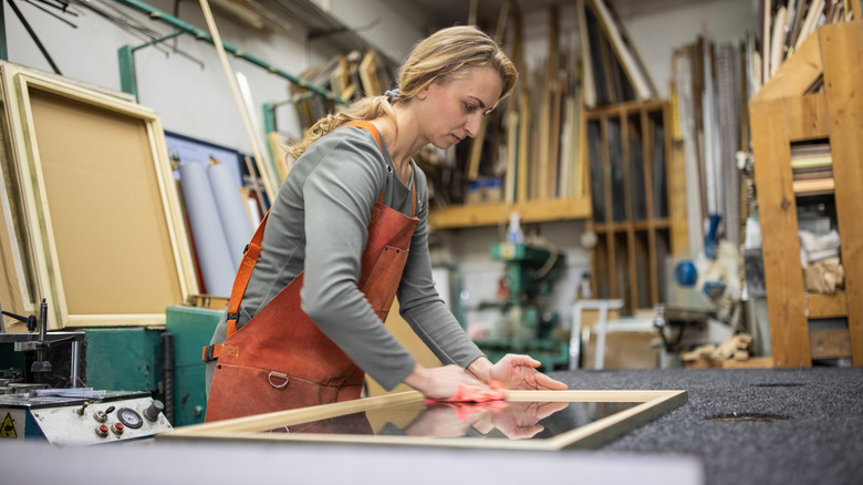 Woman working on picture frame