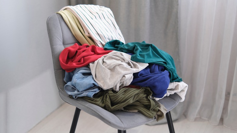 pile of clothes on chair 