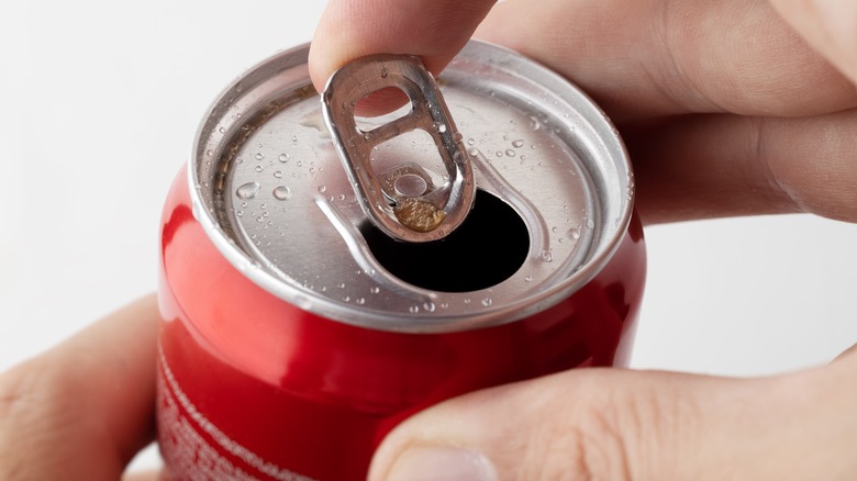 hand opening can of coke