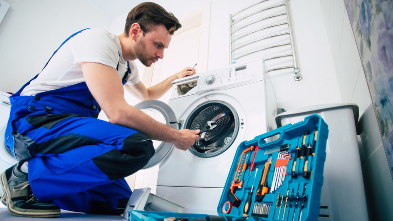 handyman fixing washer