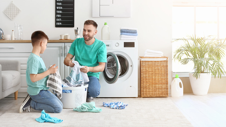 man and son doing laundry