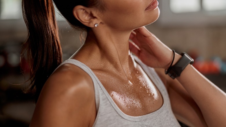 Lady in workout top perspiring