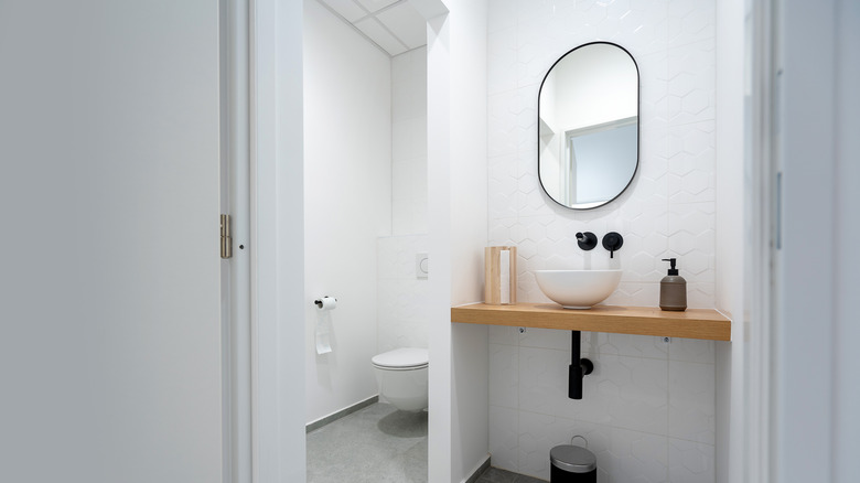 Modern bathroom with circular mirror