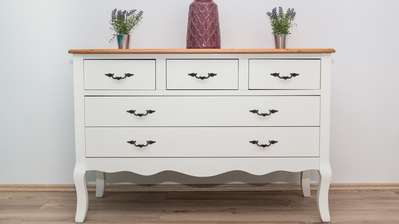 white dresser with flowers on top