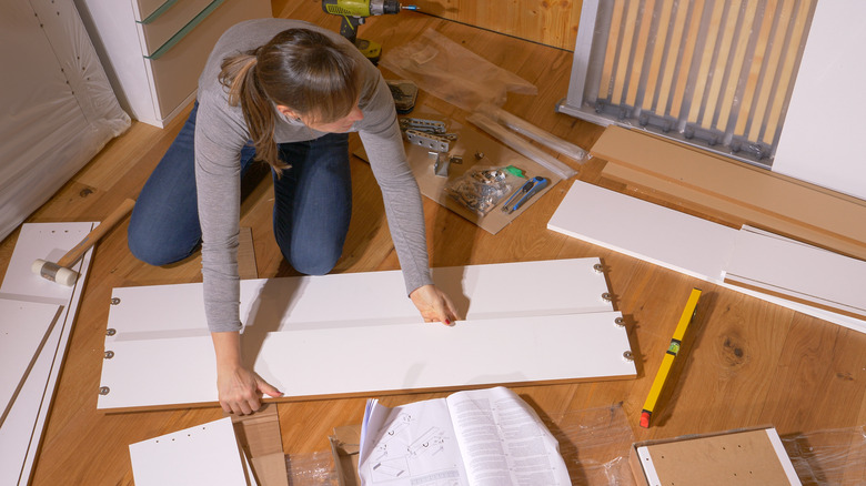 person assembling dresser