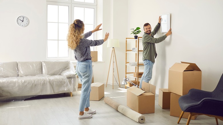 couple decorating neutral room