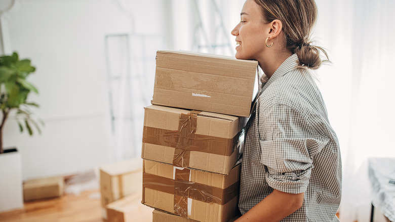 Woman carrying moving boxes