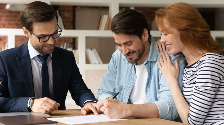 Couple signing loan closing documents