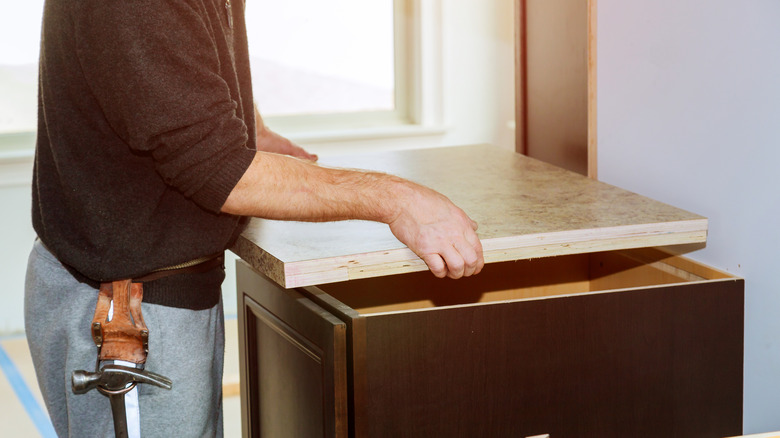 Man installing laminate countertops