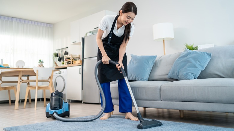 woman vacuuming house