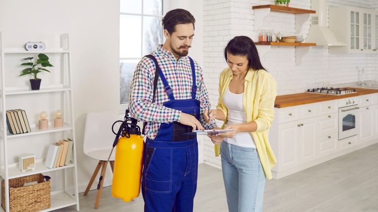 Woman talking to pest control professional