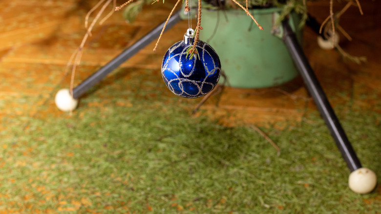 Needles underneath blue ornament