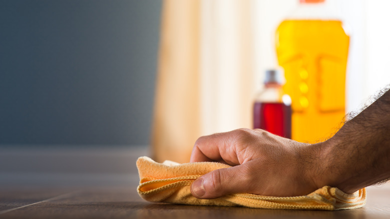 Man wiping a wooden floor