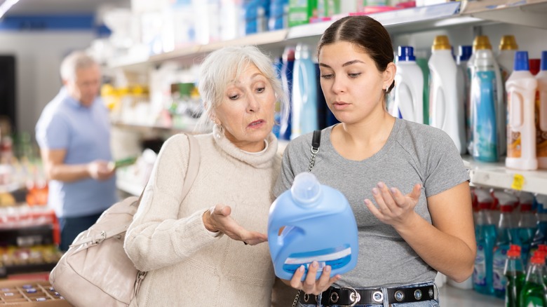 Women holding laundry detergent