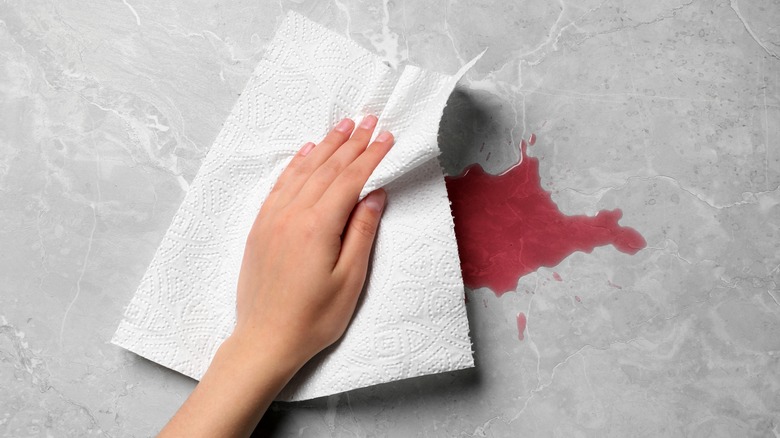 wiping spill with paper towel