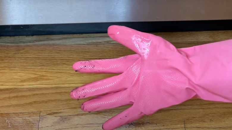 Pink glove cleaning floor