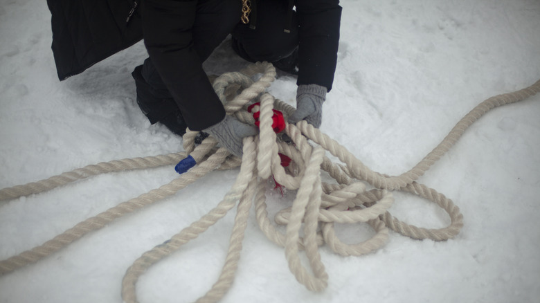 person holding rope in snow