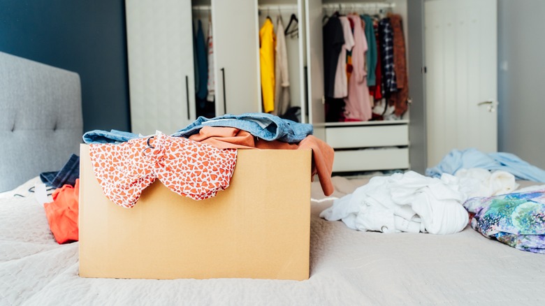 Box with clothing on bed