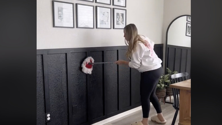 woman mopping baseboards