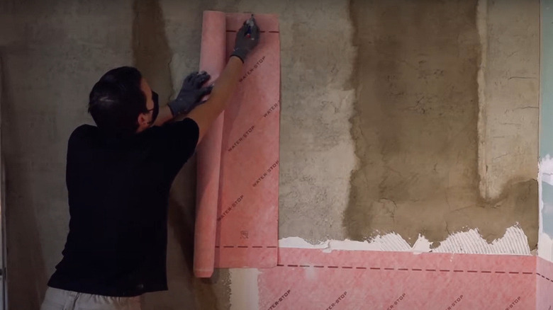 Applying membrane to basement walls