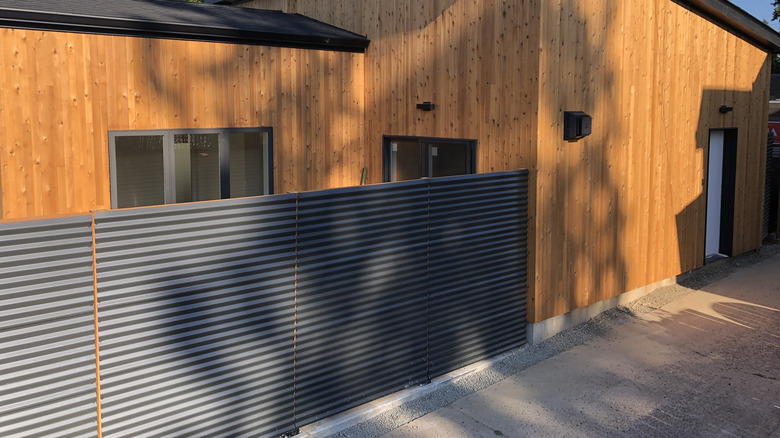 Corrugated metal fence outside ADU