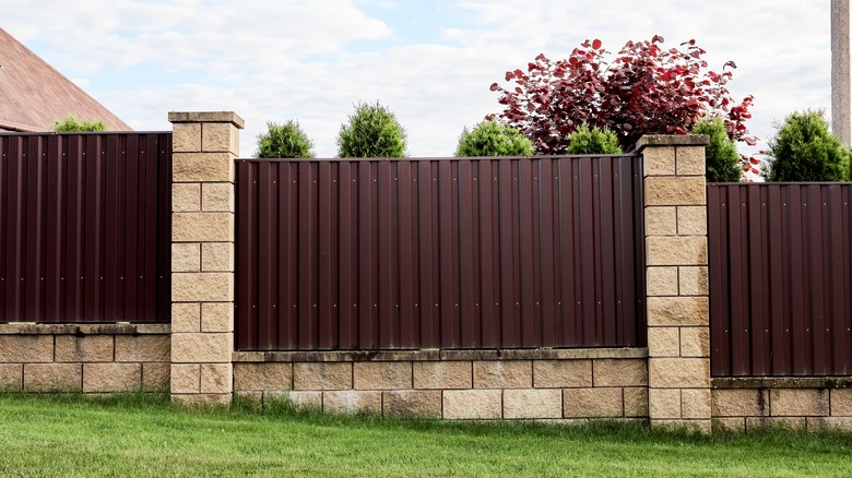 Corrugated metal fence on incline