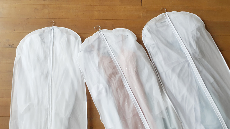 Three white garment bags