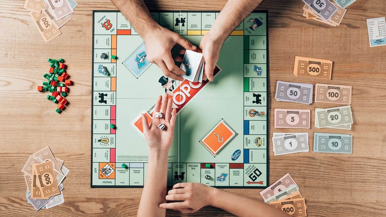 People playing Monopoly 