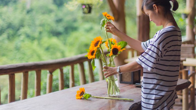 person trying to arrange sunflowers