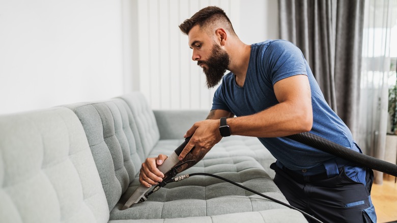 Man deep cleaning furniture