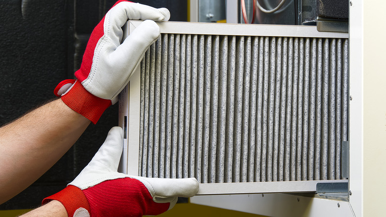 Person changes dirty air filter