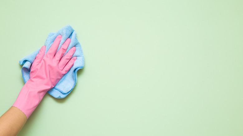 Person scrubbing wall