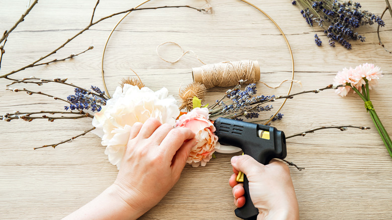 Person making floral wire wreath