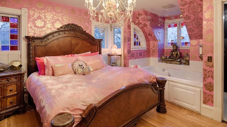 Jacuzzi in pink-themed room 