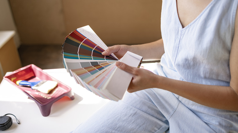 person looking at paint samples