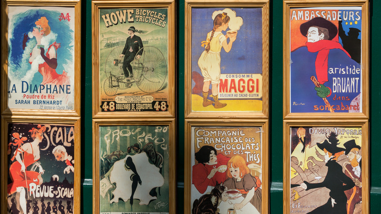 selection of art nouveau-era framed prints on a wall