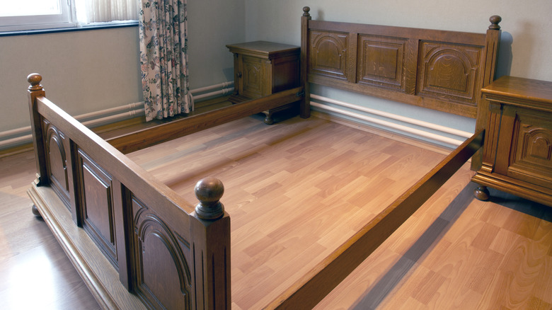 An antique wooden bed in a bedroom