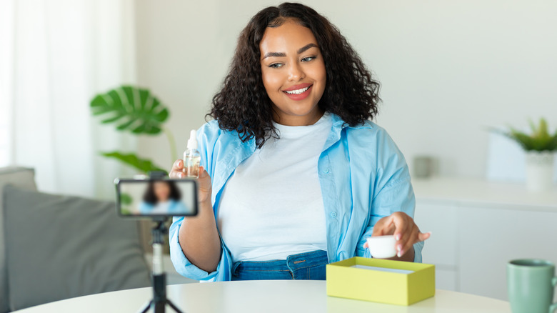 Woman showing products to phone camera