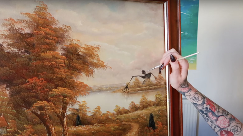 tattooed artist painting over art