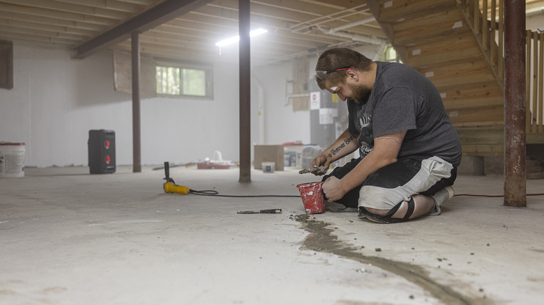 worker sealing basement